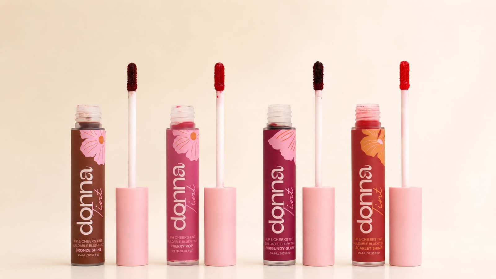 Four Donna Lip & Cheek Tint shades with their applicators